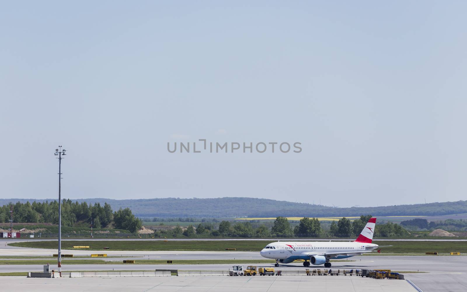 VIENNA, AUSTRIA – APRIL 30th 2016: Plane moving to take off area at Vienna International Airport on a busy Saturday.