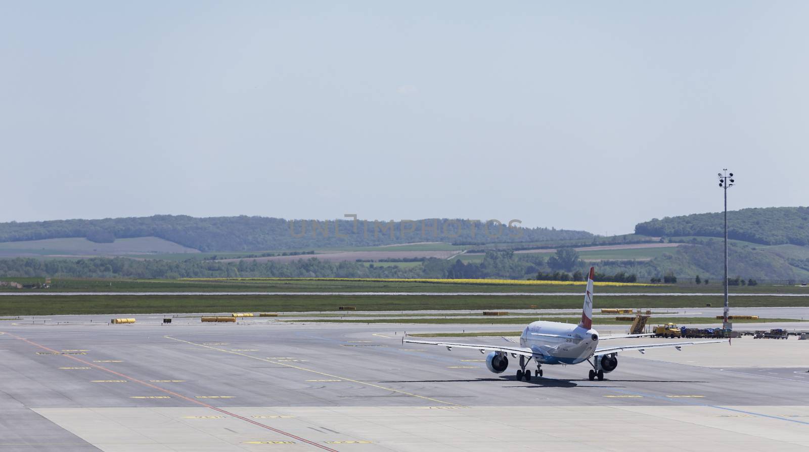 VIENNA, AUSTRIA – APRIL 30th 2016: Plane leaving terminal area on a busy Saturday at Vienna International Airport.