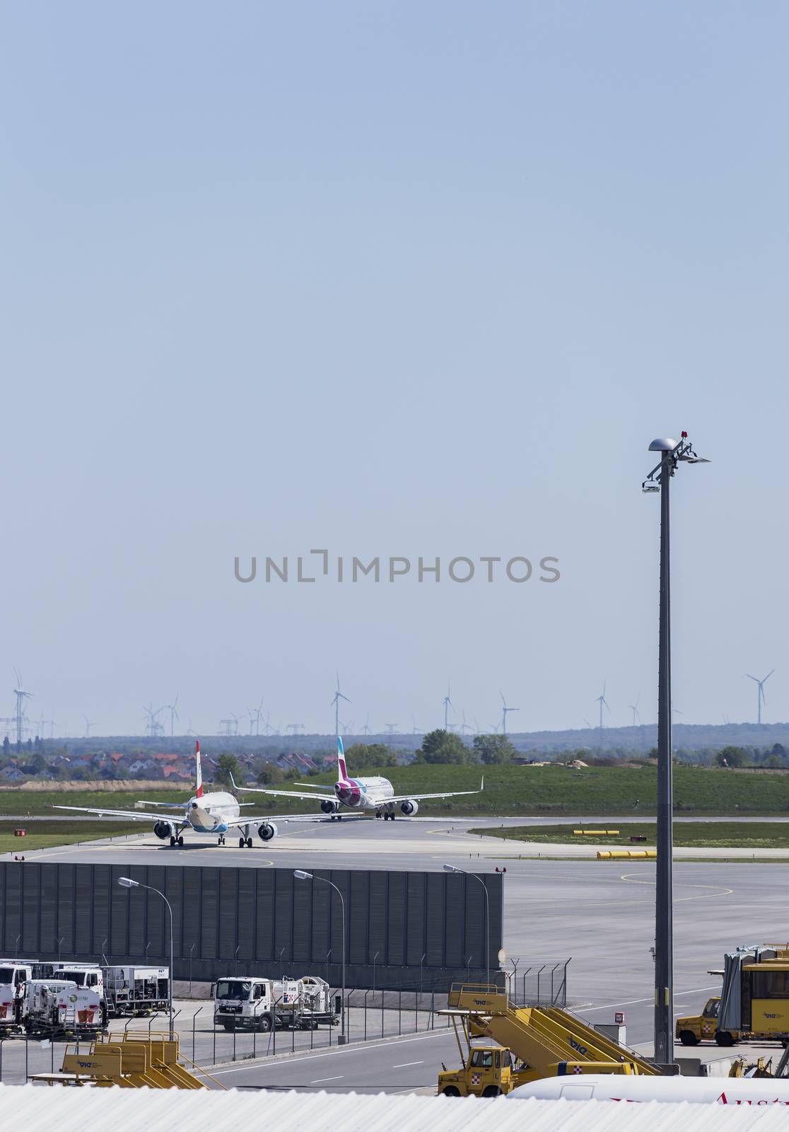VIENNA, AUSTRIA – APRIL 30th 2016: Planes lined up a busy Saturday ready for take off at Vienna International Airport.