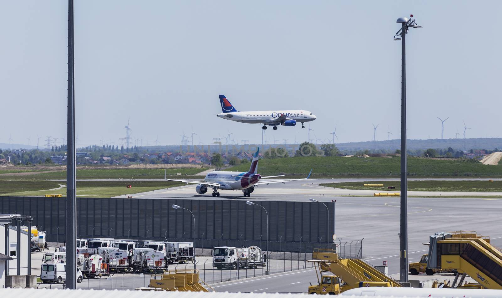 VIENNA, AUSTRIA – APRIL 30th 2016: Plane landing on a busy Saturday at Vienna International Airport.