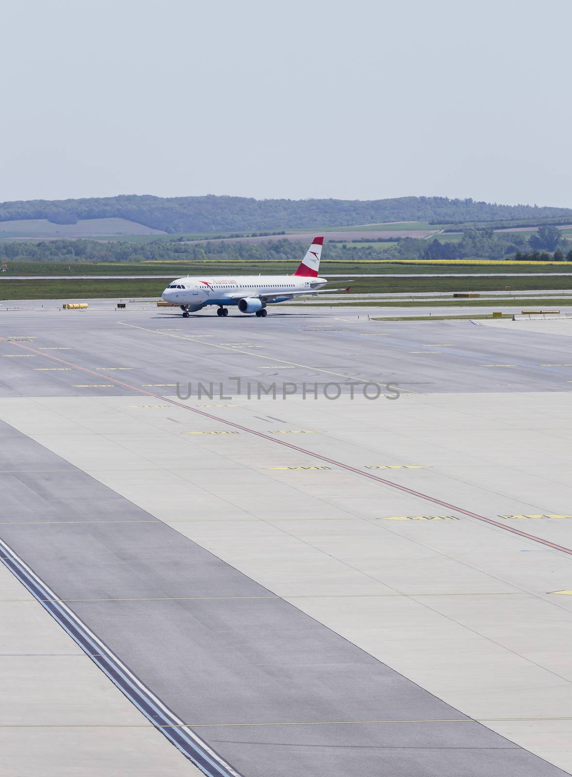 VIENNA, AUSTRIA – APRIL 30th 2016: Plane arriving to terminal area at Vienna International Airport on a busy Saturday.