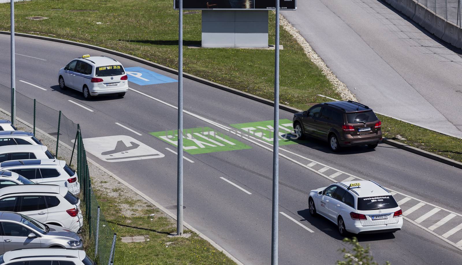 VIENNA, AUSTRIA – APRIL 30th 2016: Cars leaving the parking area at Vienna International Airport on a busy Saturday.