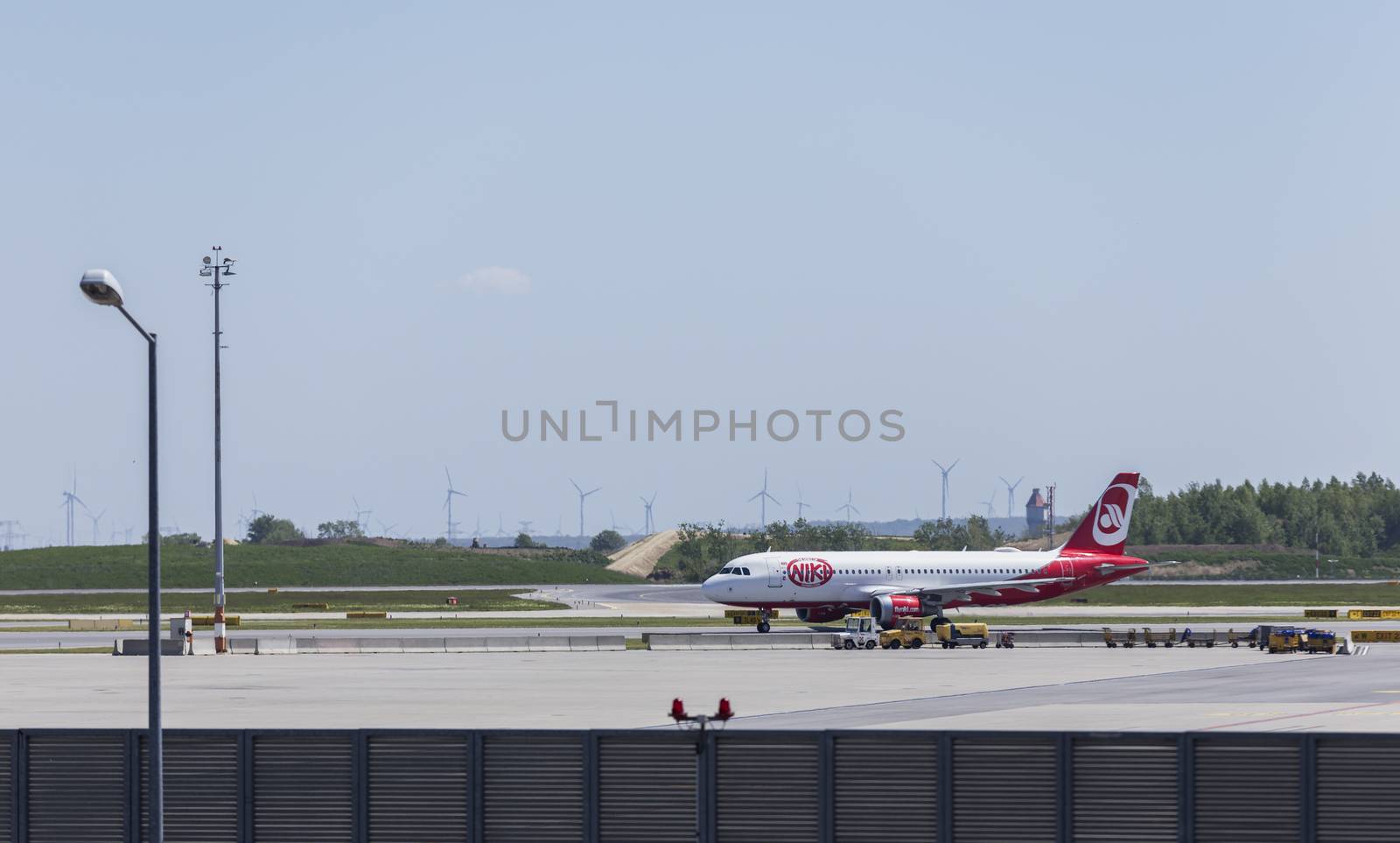 VIENNA, AUSTRIA – APRIL 30th 2016: Plane moving to take off area at Vienna International Airport on a busy Saturday.