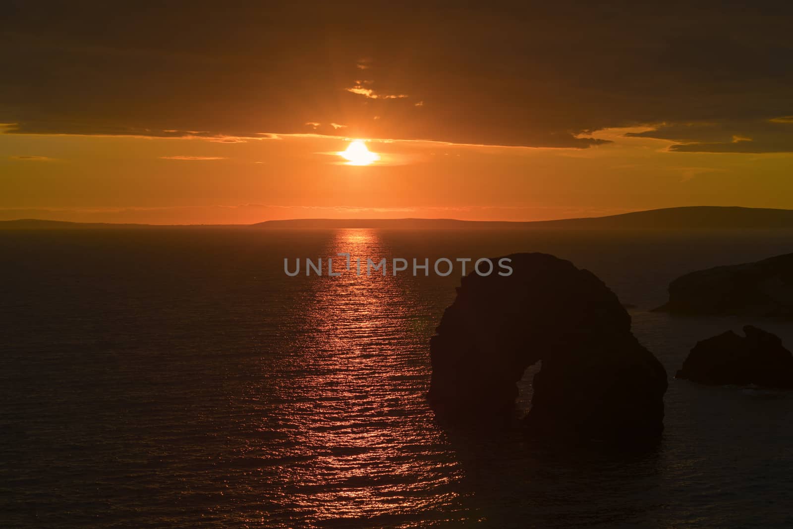 virgin rock sunset on the coastline by morrbyte