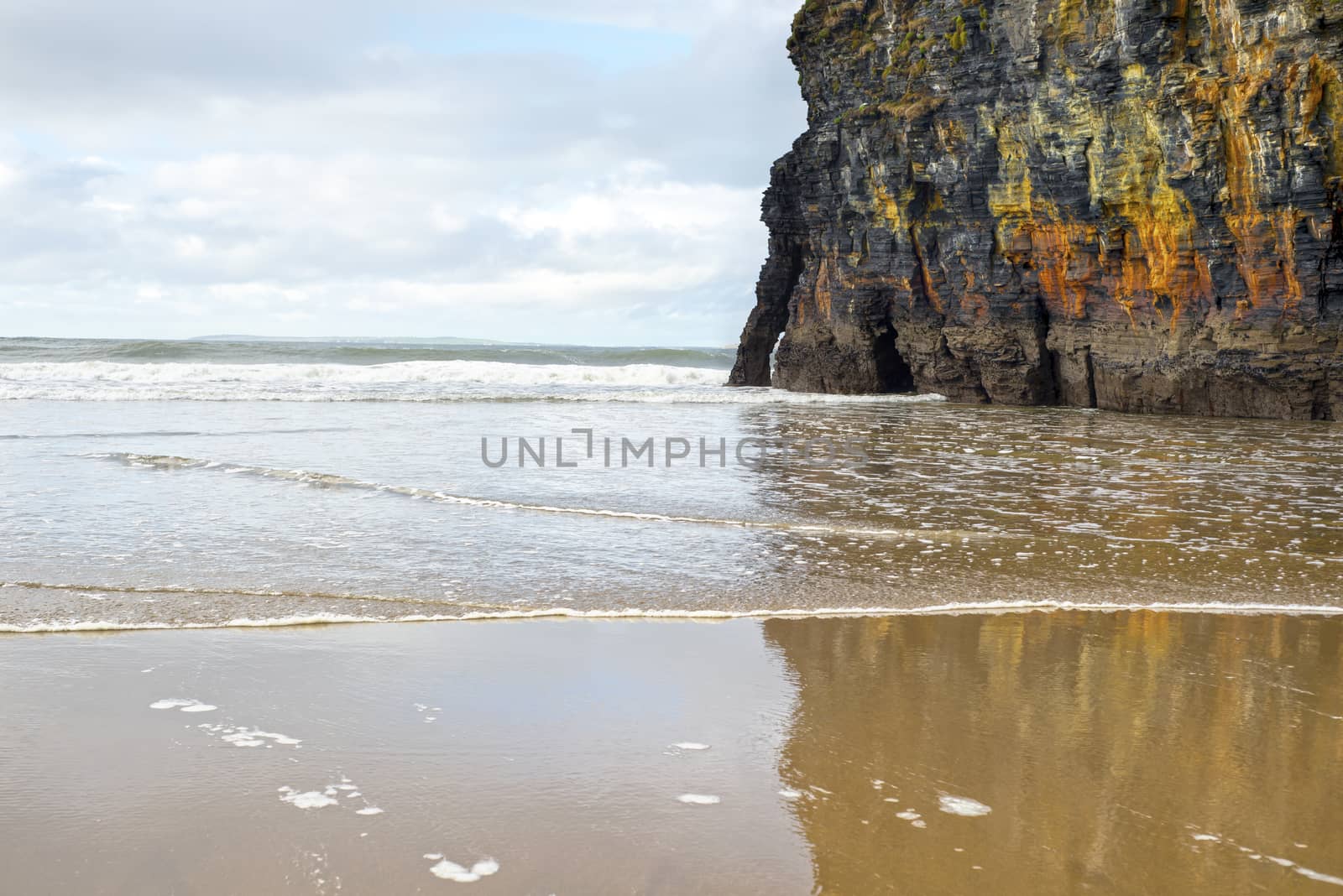 wet sand and cliff reflections on the wild atlantic way in Ballybunion Ireland