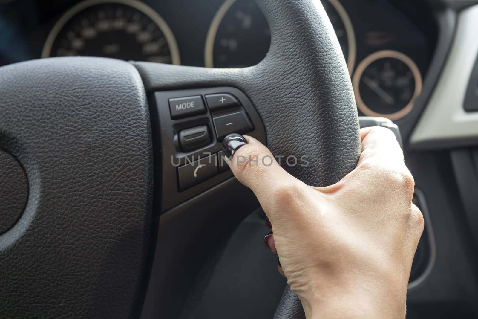 Car wheel hand of a young girl with a manicure.