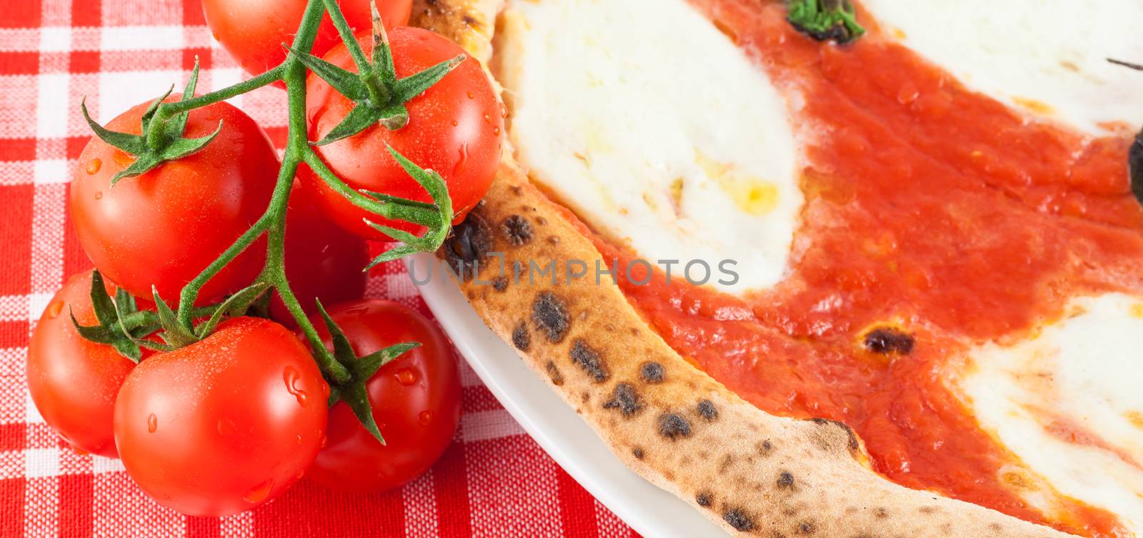 Detail of a Real Italian Pizza in Naples with Ciliegino tomatos