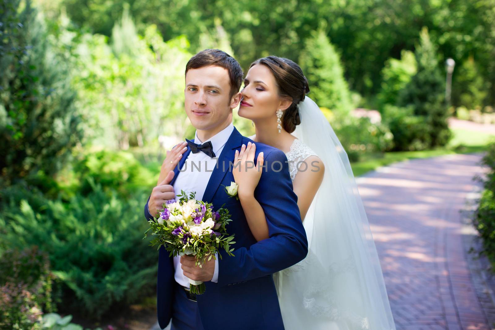 Funny bride and groom on a summer day in the park