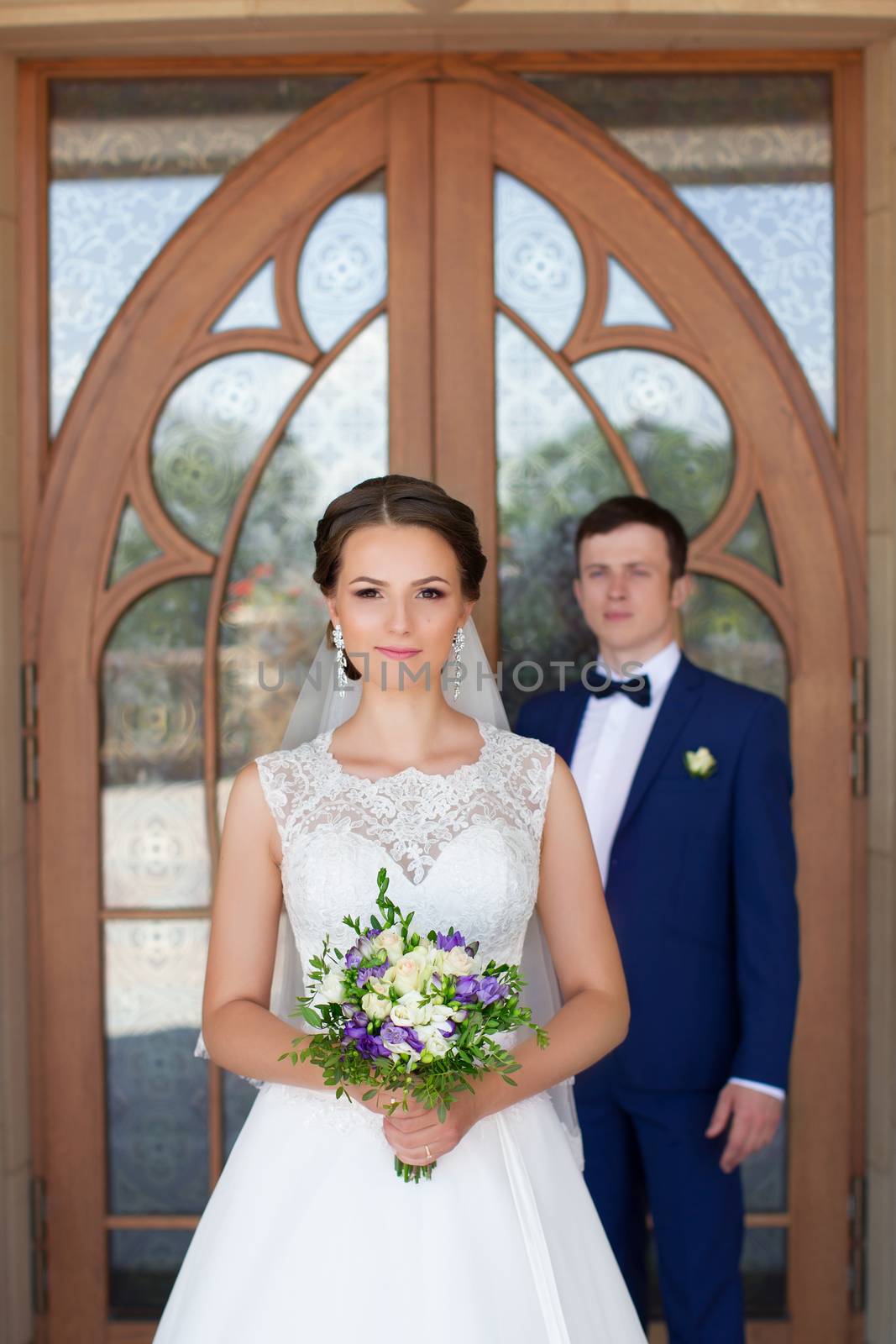 Funny bride and groom on a summer day in the park