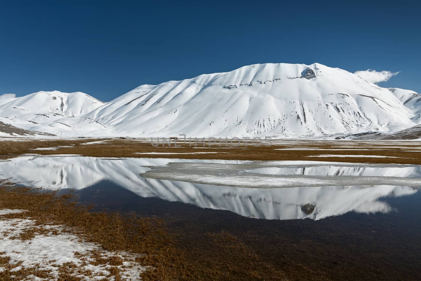 Sibillini mountains reflected in the water with snow by LuigiMorbidelli