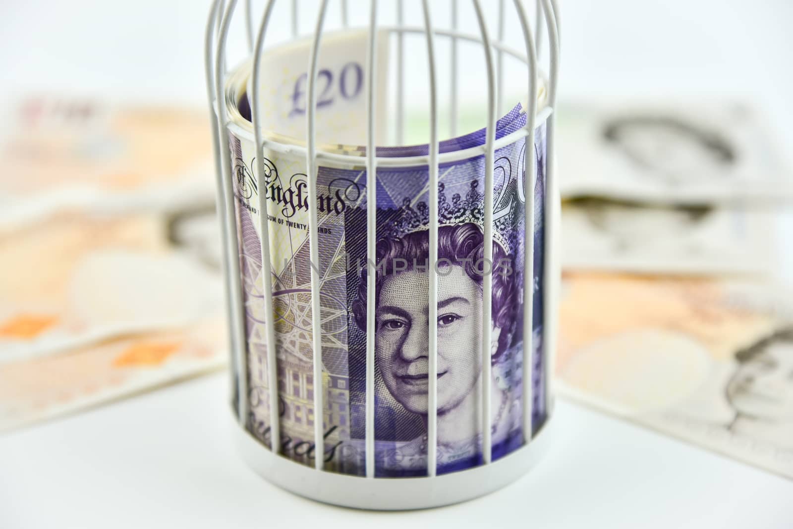 Banknotes trapped inside the cage, behind bars