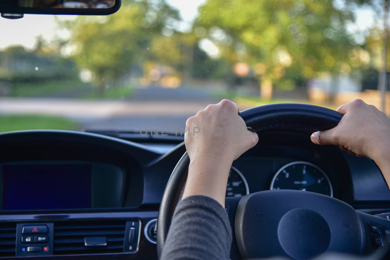 A woman driving a modern car.