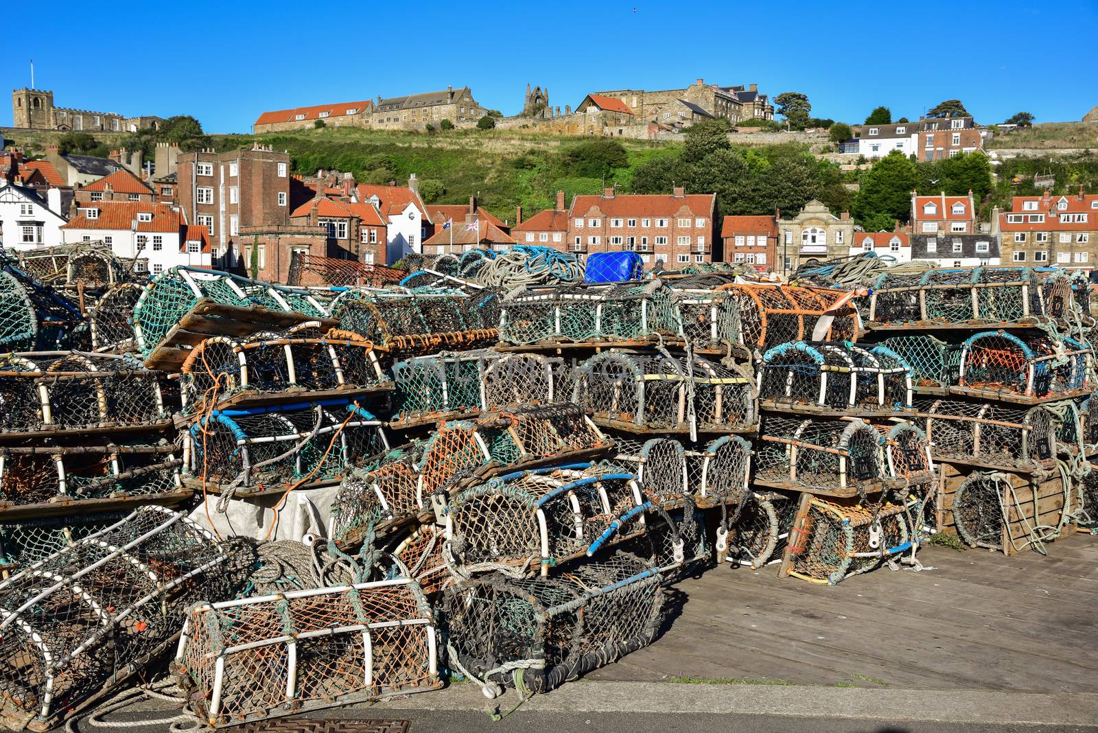 Colourful lobster pots standing on the quayside in Whitby, North Yorkshire, England.