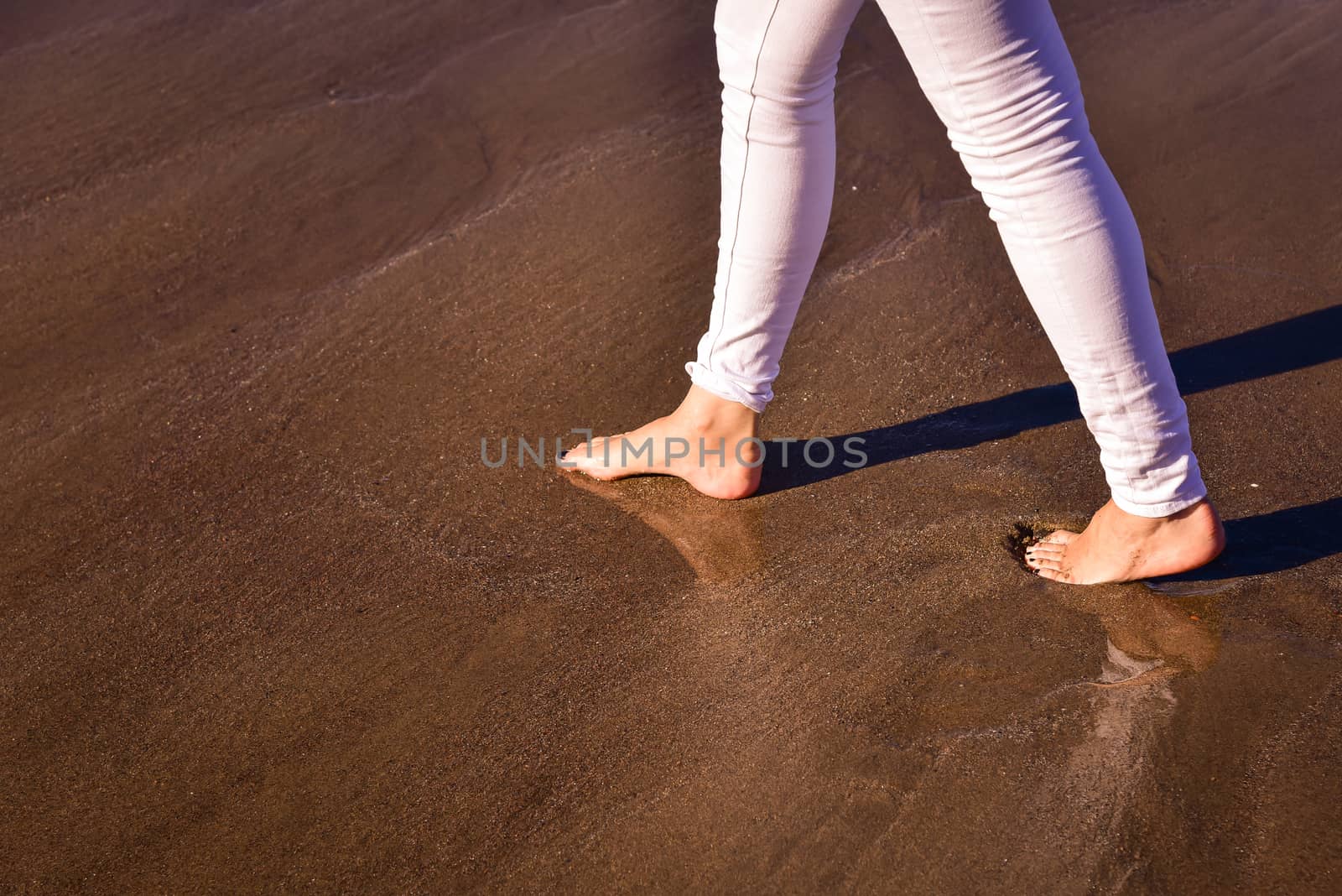 Lonely woman walking along the beach