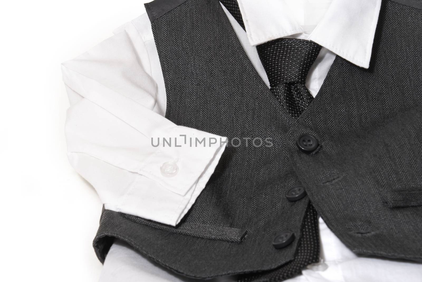 An infants dress shirt and vest are laid out for the parents to clothe their child before the formal day of events.