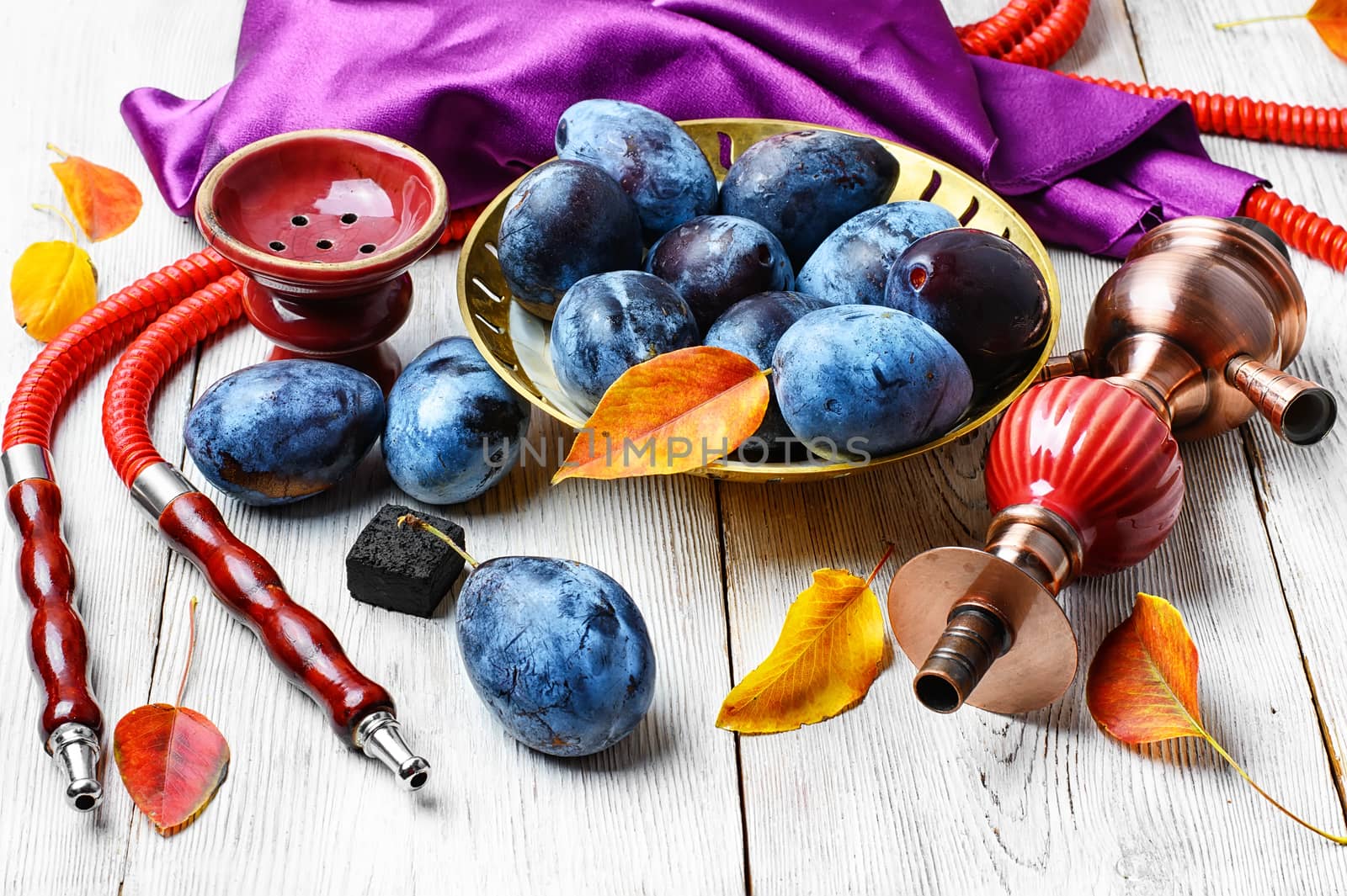 Still life with smoking hookah and the harvest of autumn plums