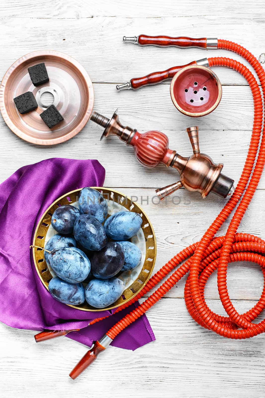 Still life with smoking hookah and the harvest of autumn plums