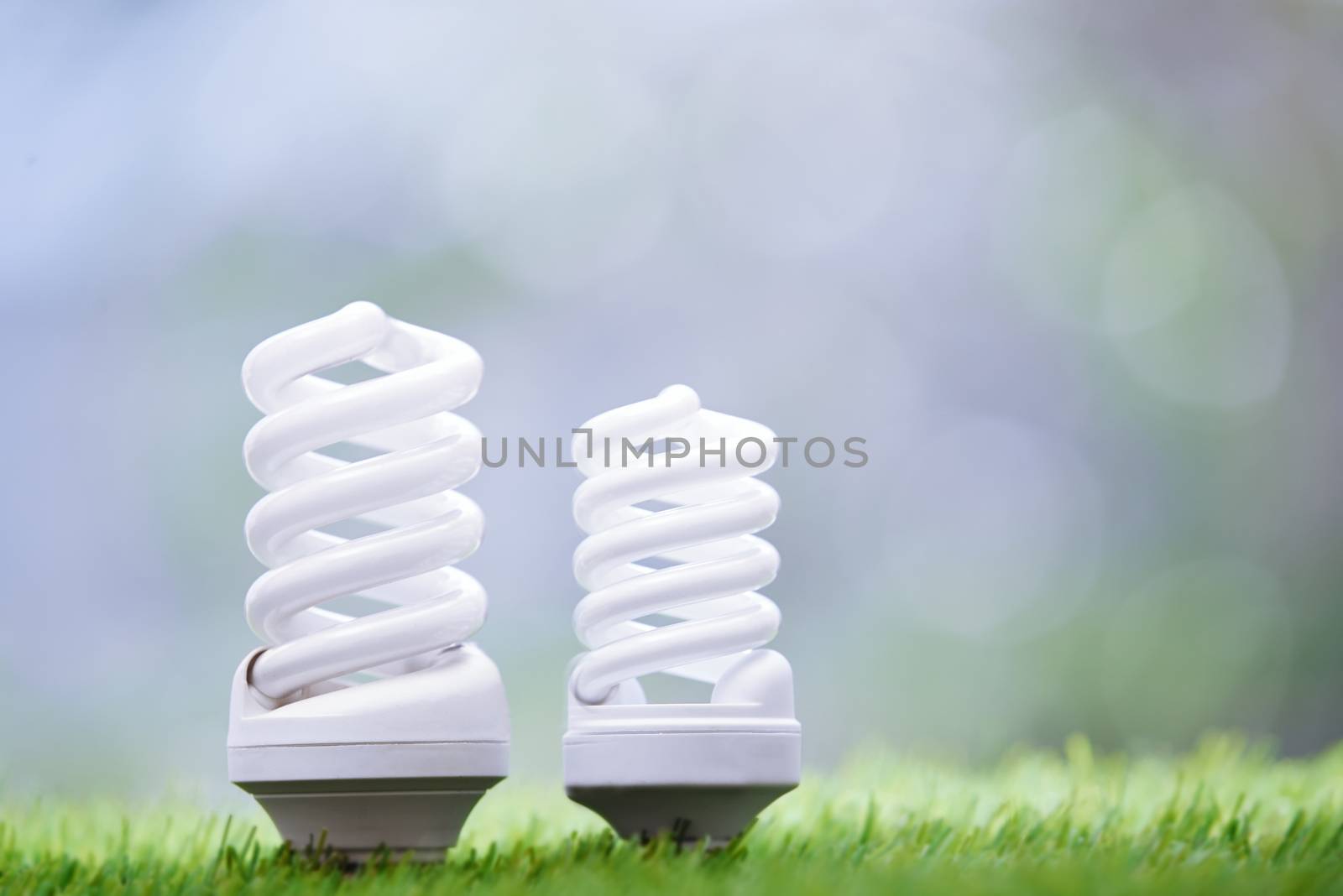 Energy saving bulbs in the grass by Novic