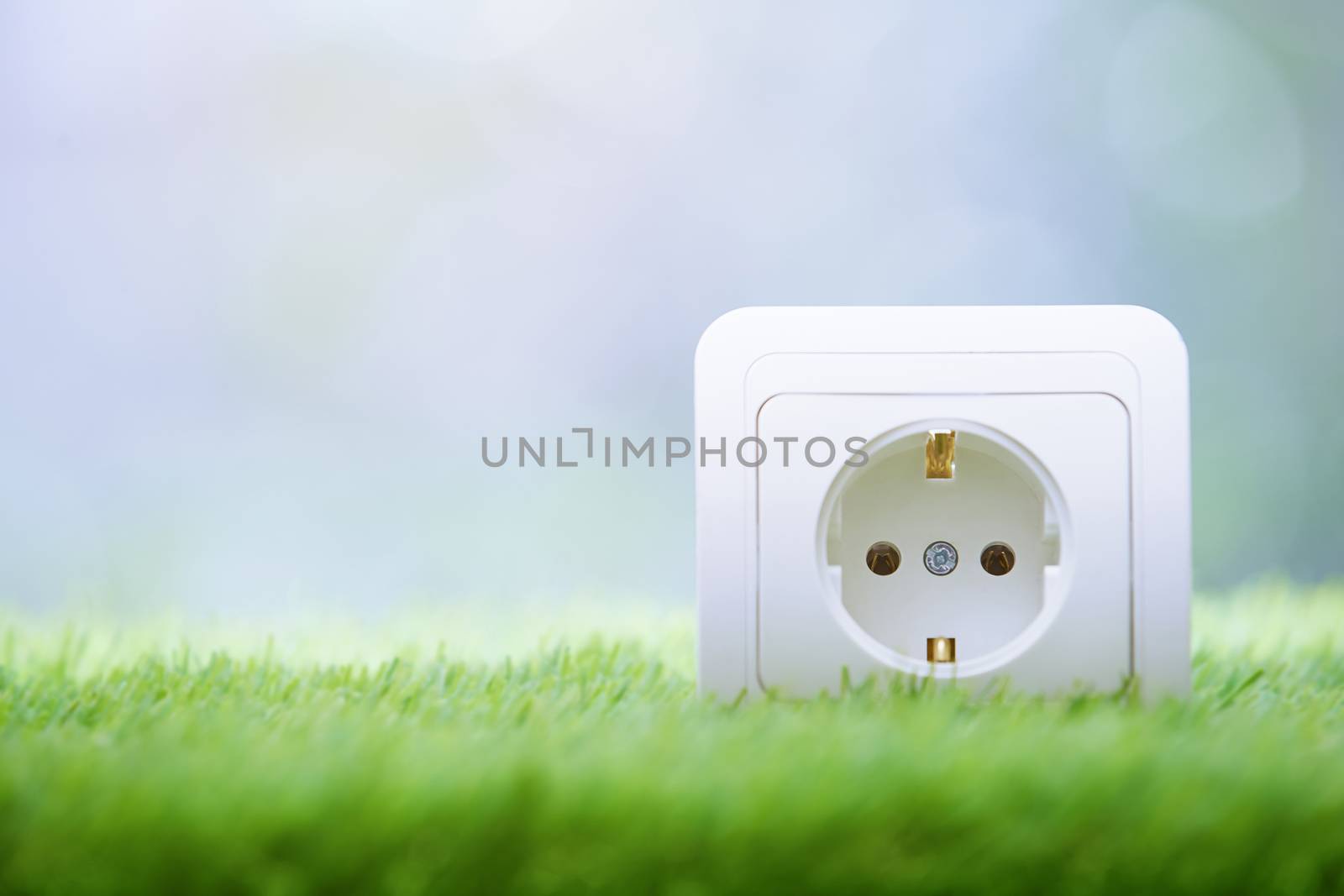 Electric outlet in the grass. Close-up photo