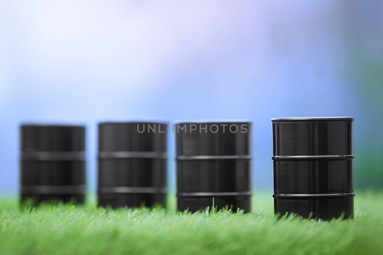 Four oil barrels in the grassland. Horizontal photo