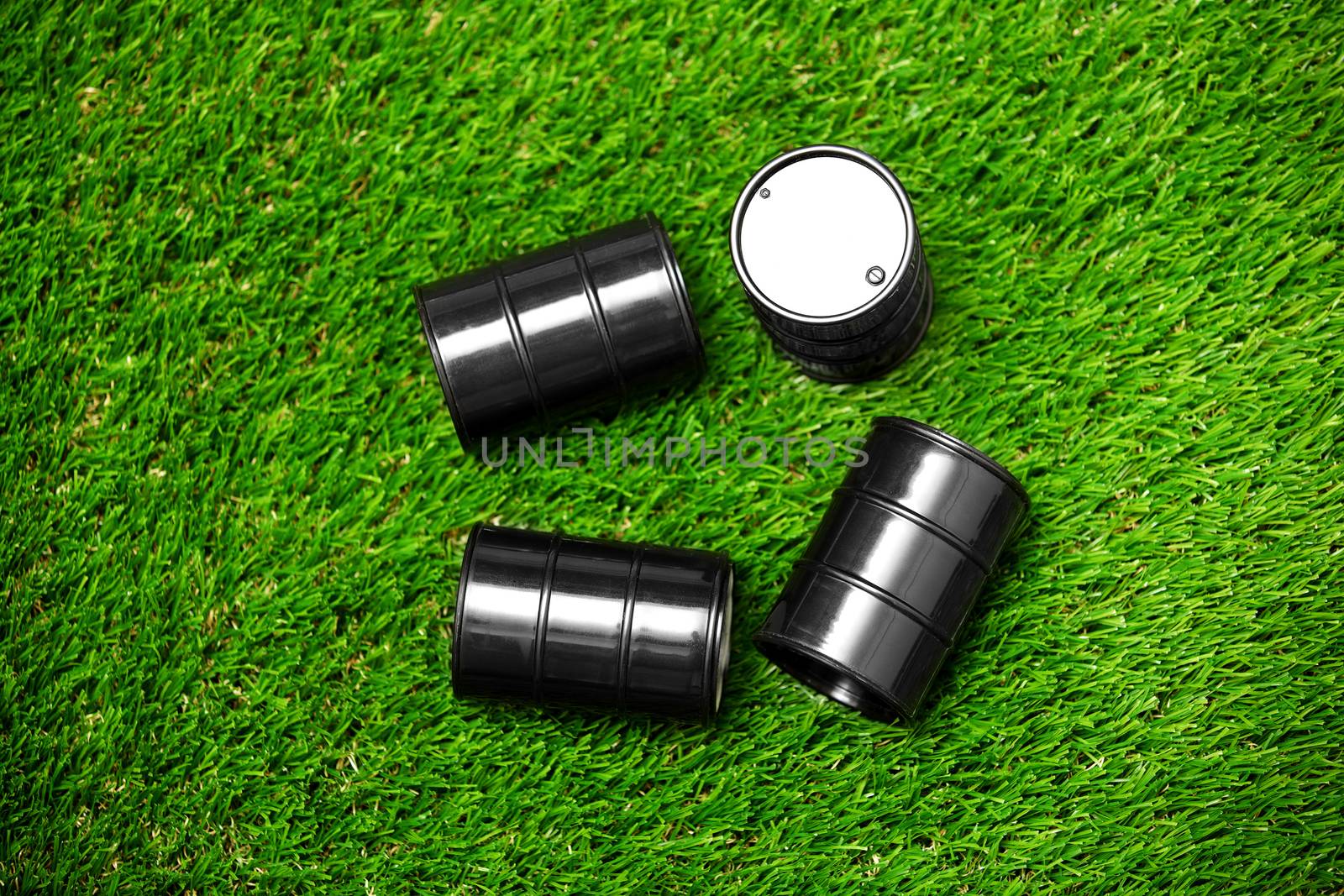 High angle view on four oil drums on a grass