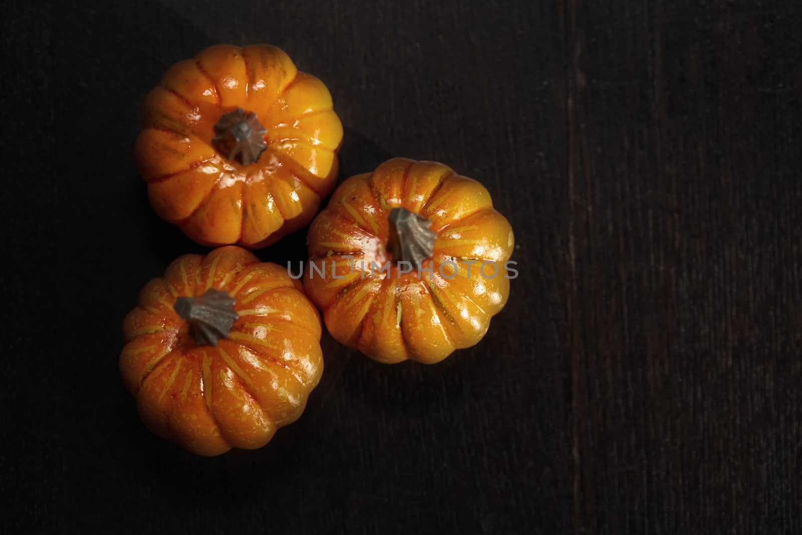 Three pumpkins on a wooden table by Novic