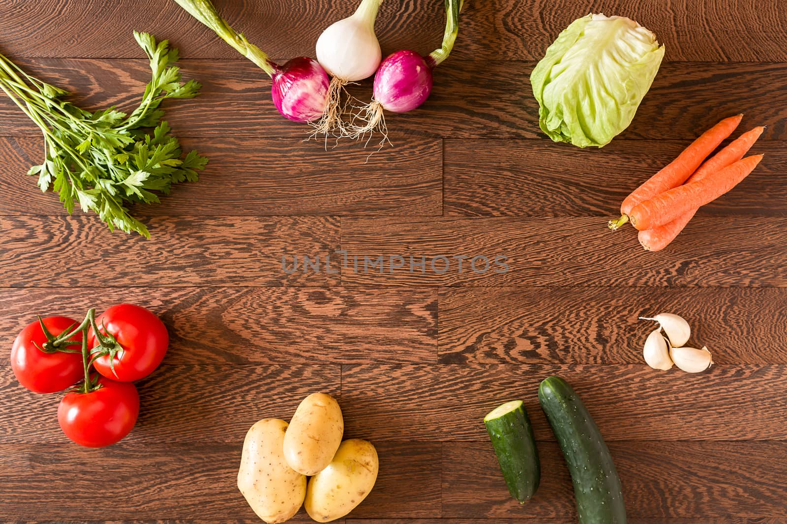 Different raw vegetables over a wooden background