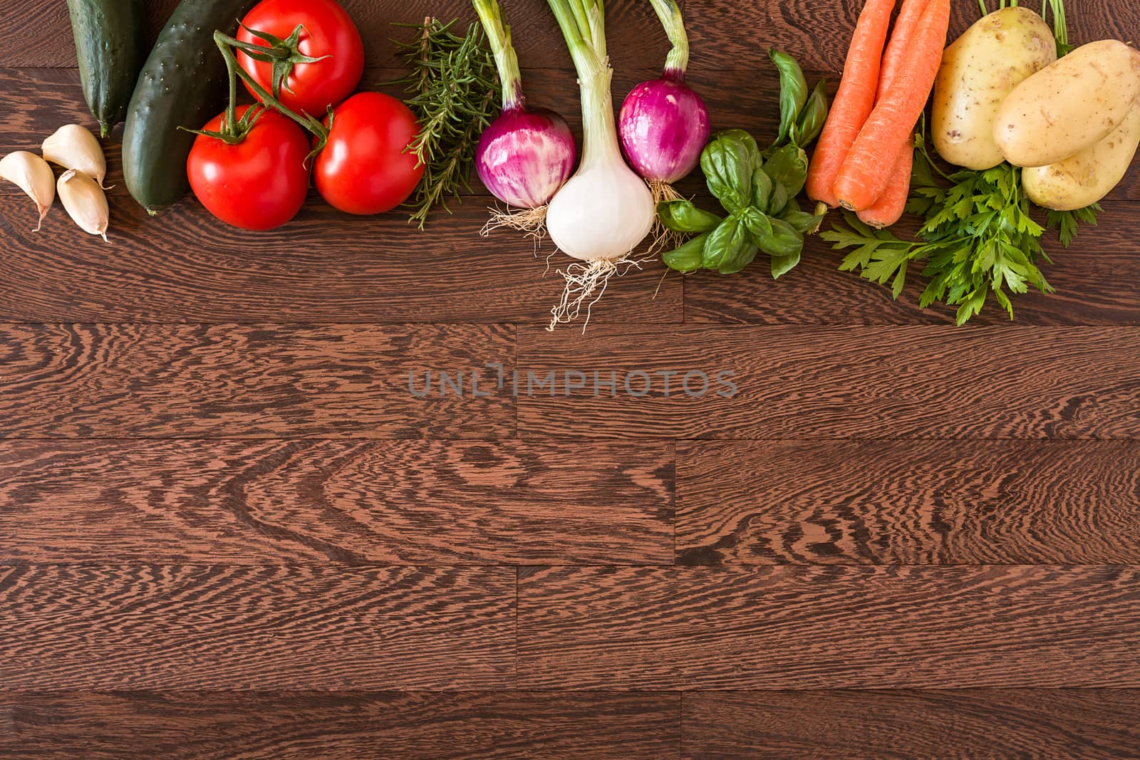 Assorted raw vegetables over a wooden background