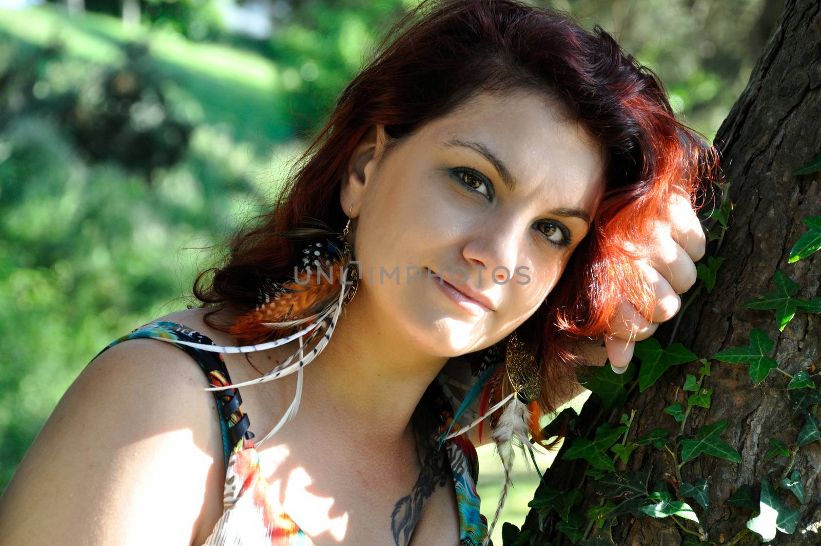 portrait of red  hair woman in a park