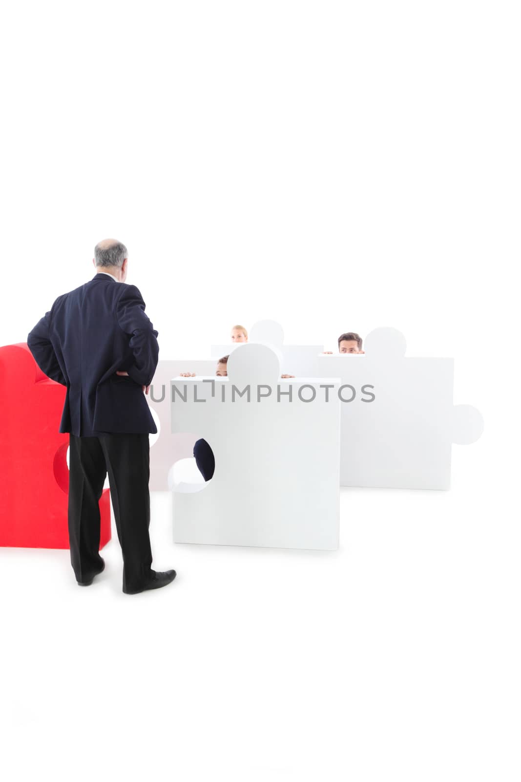 Business people hiding behind puzzle pices