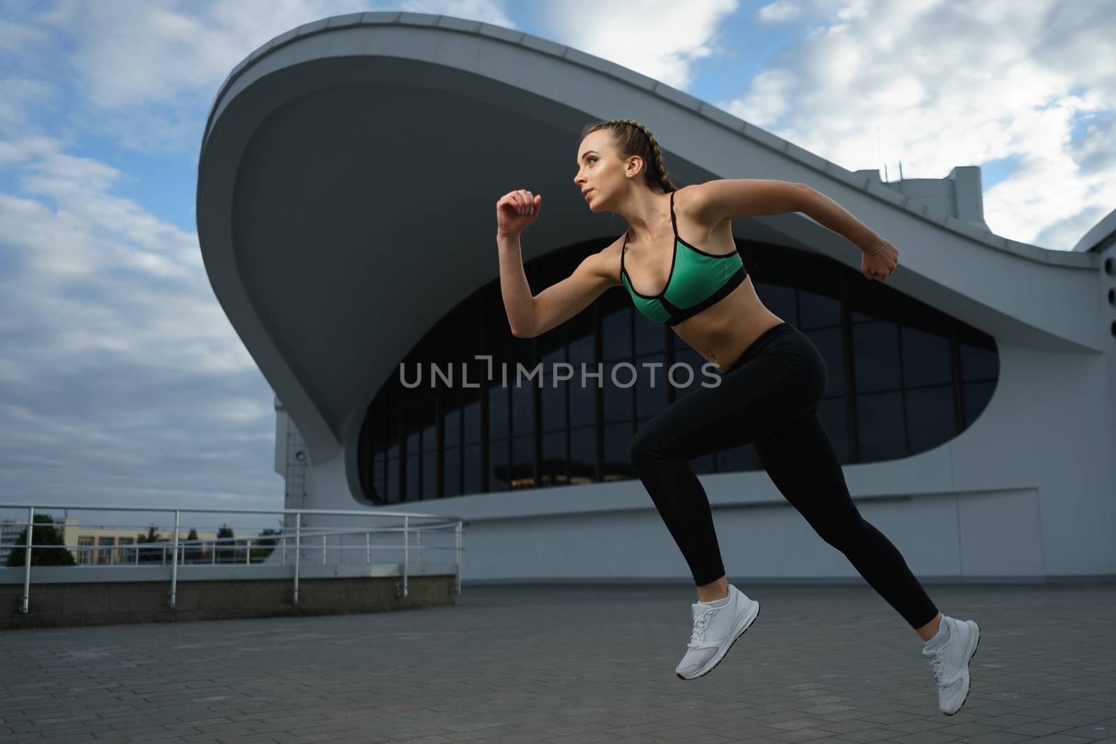 Happy girl run outdoor at modern urban area during sunset. by mrakor
