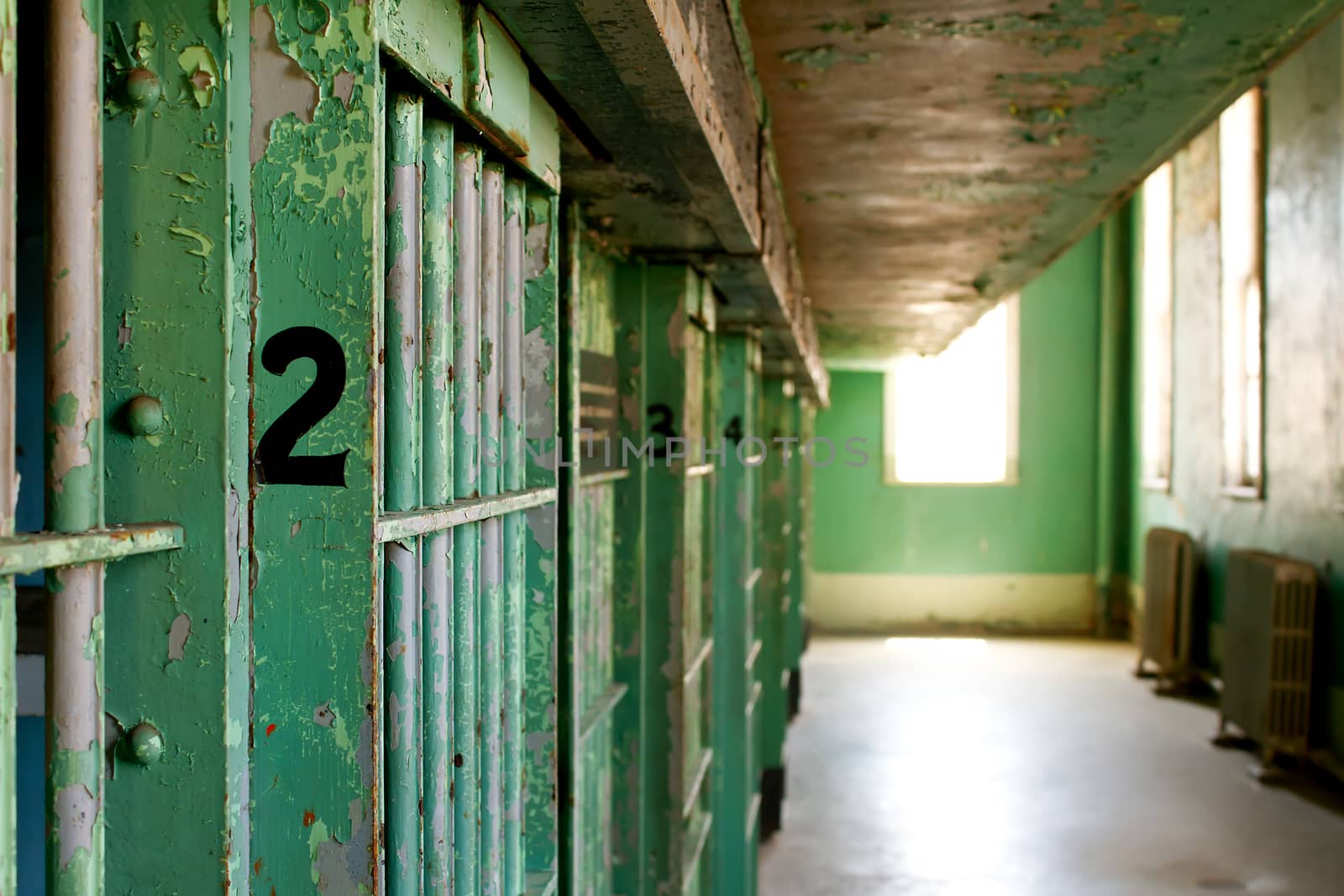 Shallow depth of field on a historic prison old worn down jail cells. focus on number 2.