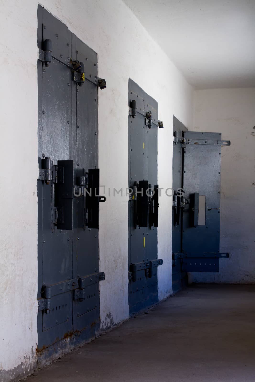 Three doors leading to solitary. Last door of the three is open