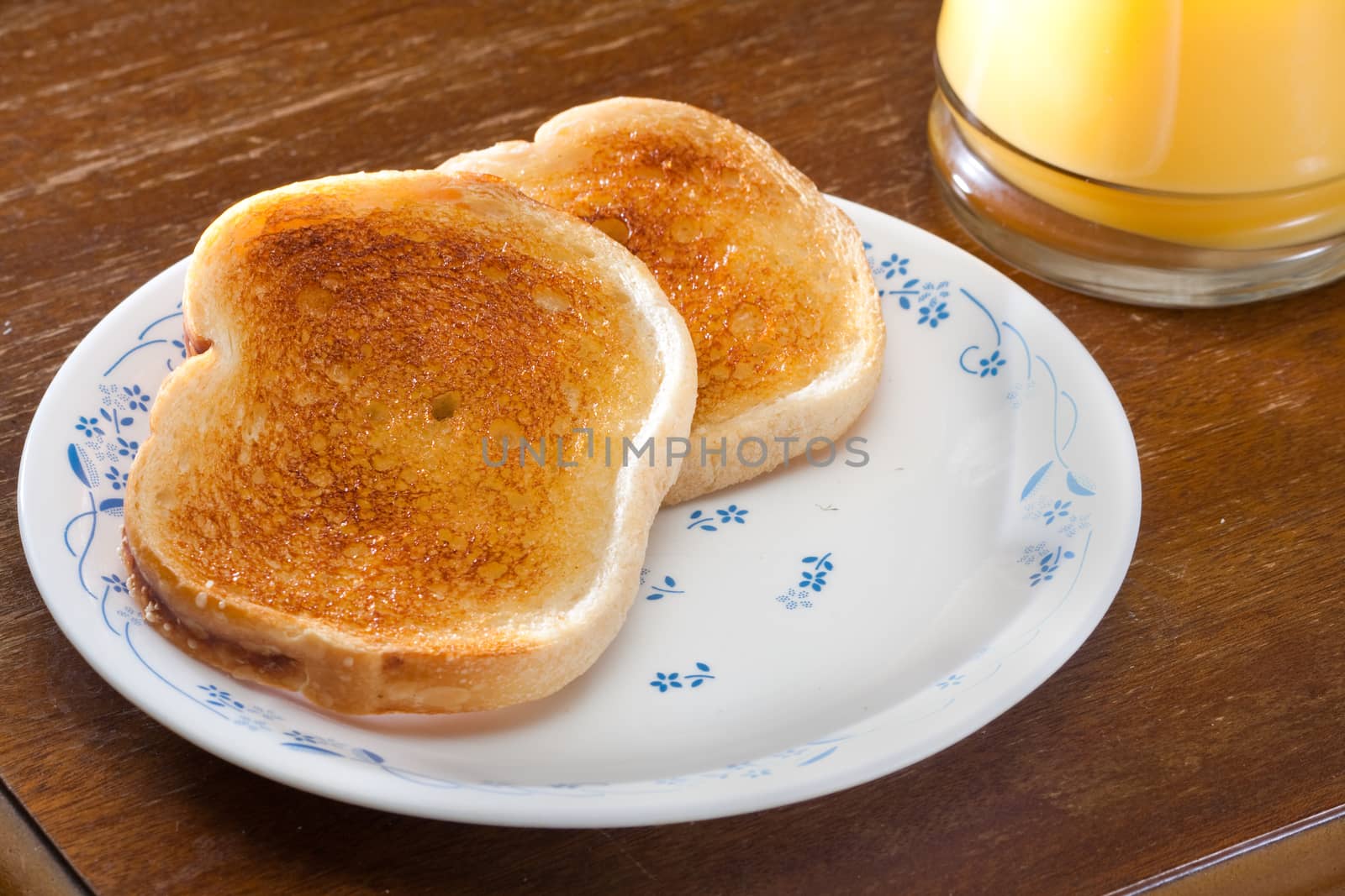 Nice breakfast of toast and orange juice ready to eat