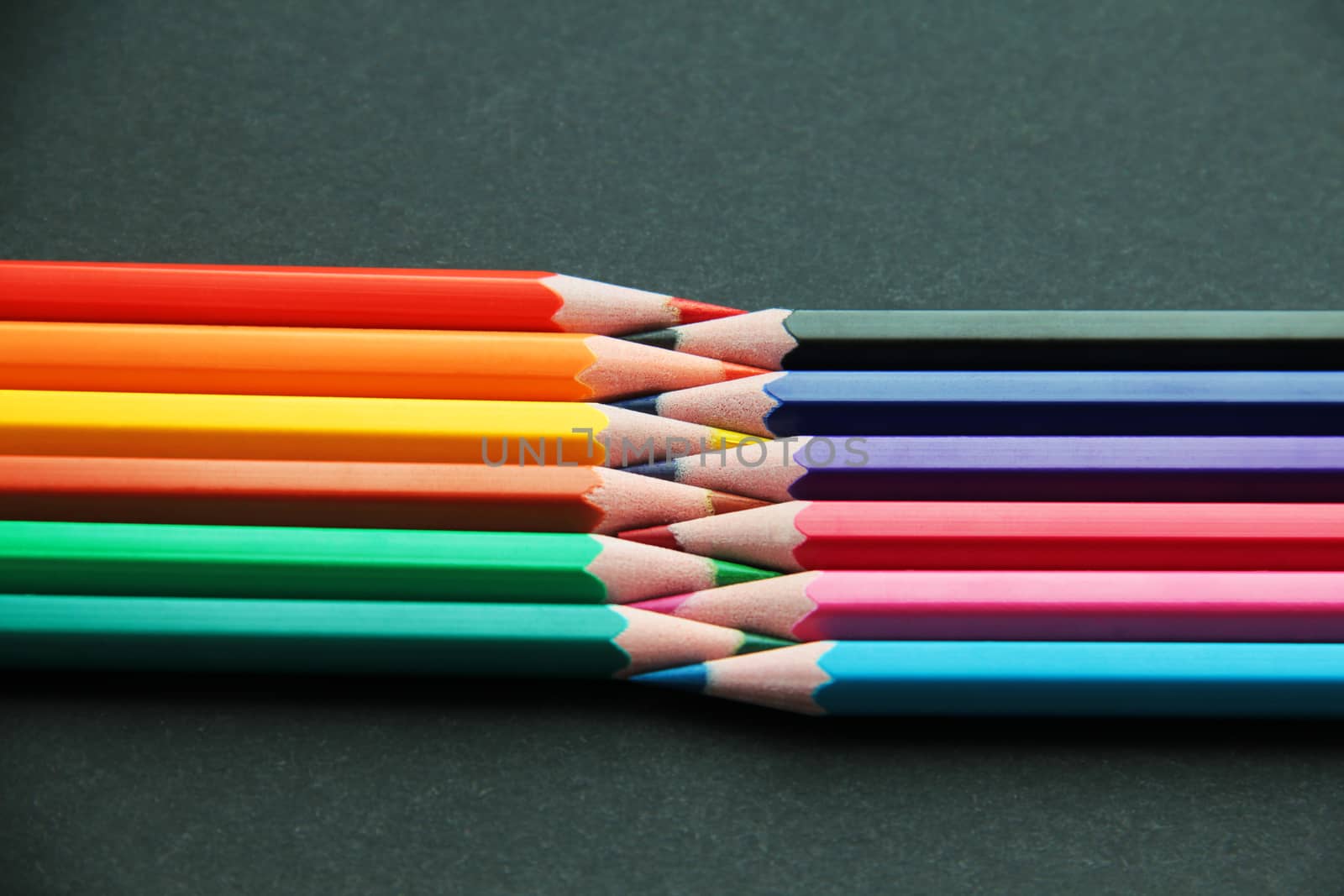 Pencils of different colors close up isolated on black