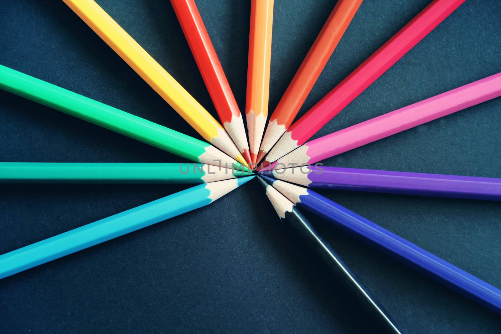 Pencils of different colors close up isolated on black