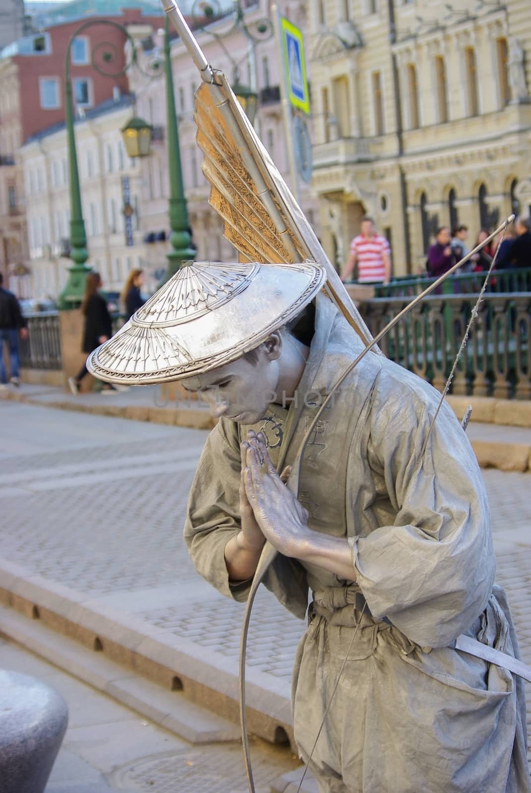ST PETERSBURG, RUSSIA - JANUARY 01, 2016: a performer - Silver painted artists on a city street, living statues by evolutionnow