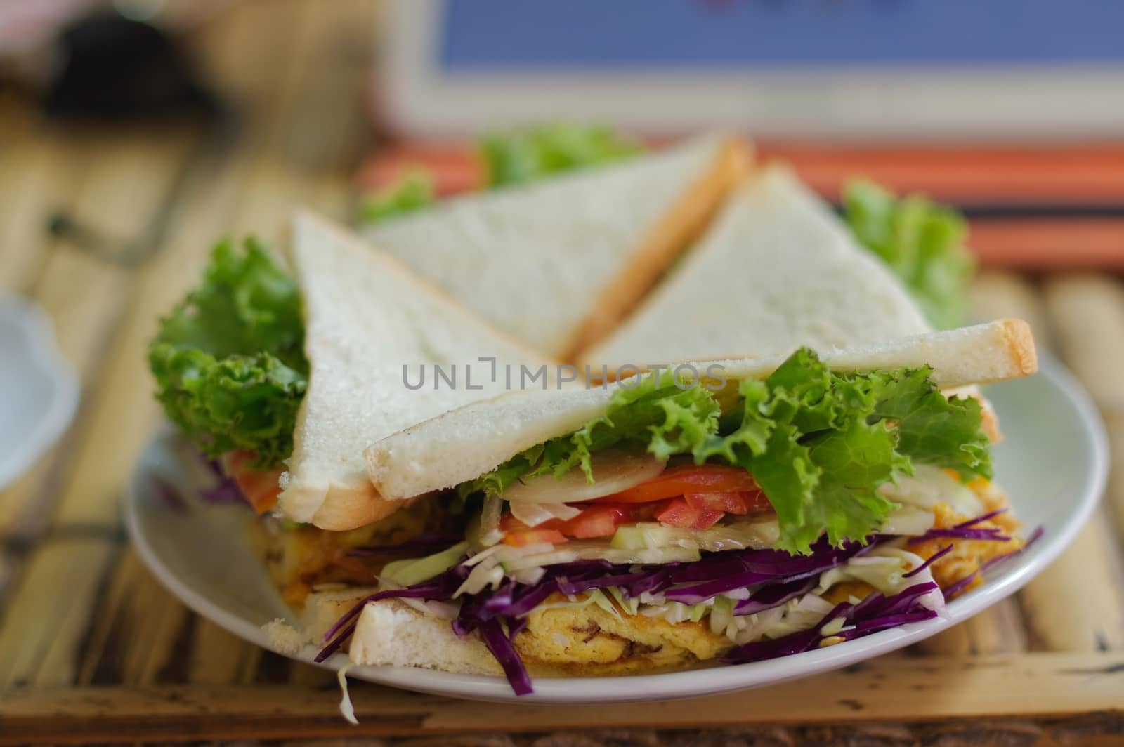 a vegetable triangle Sandwiches and crisps on a wooden table in a restaurant