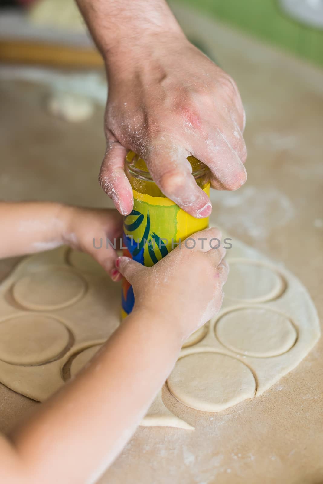 Children hands cook the circles of dough by okskukuruza