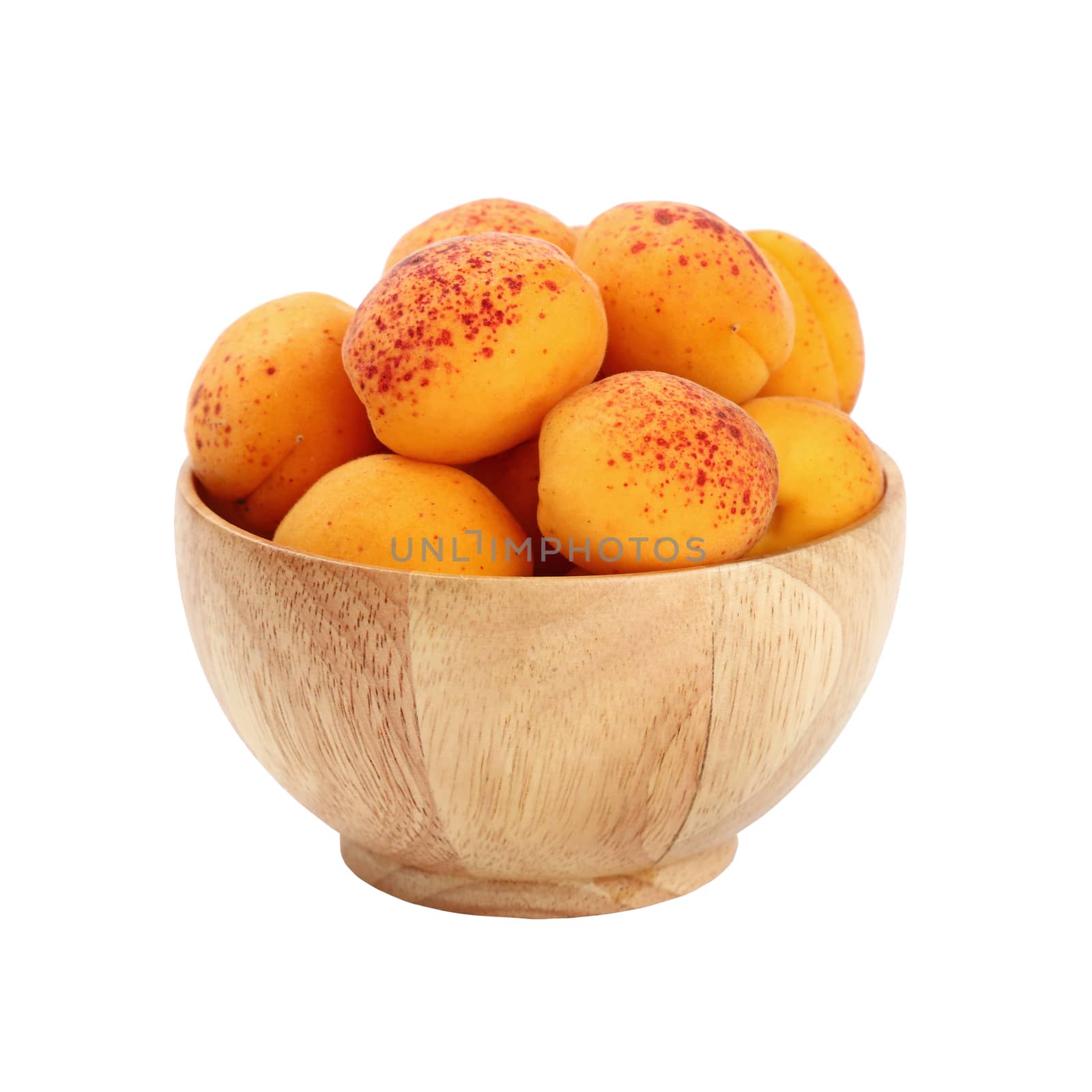 Mellow ripe fresh apricots with in small wooden bowl isolated on white background, close up, side view
