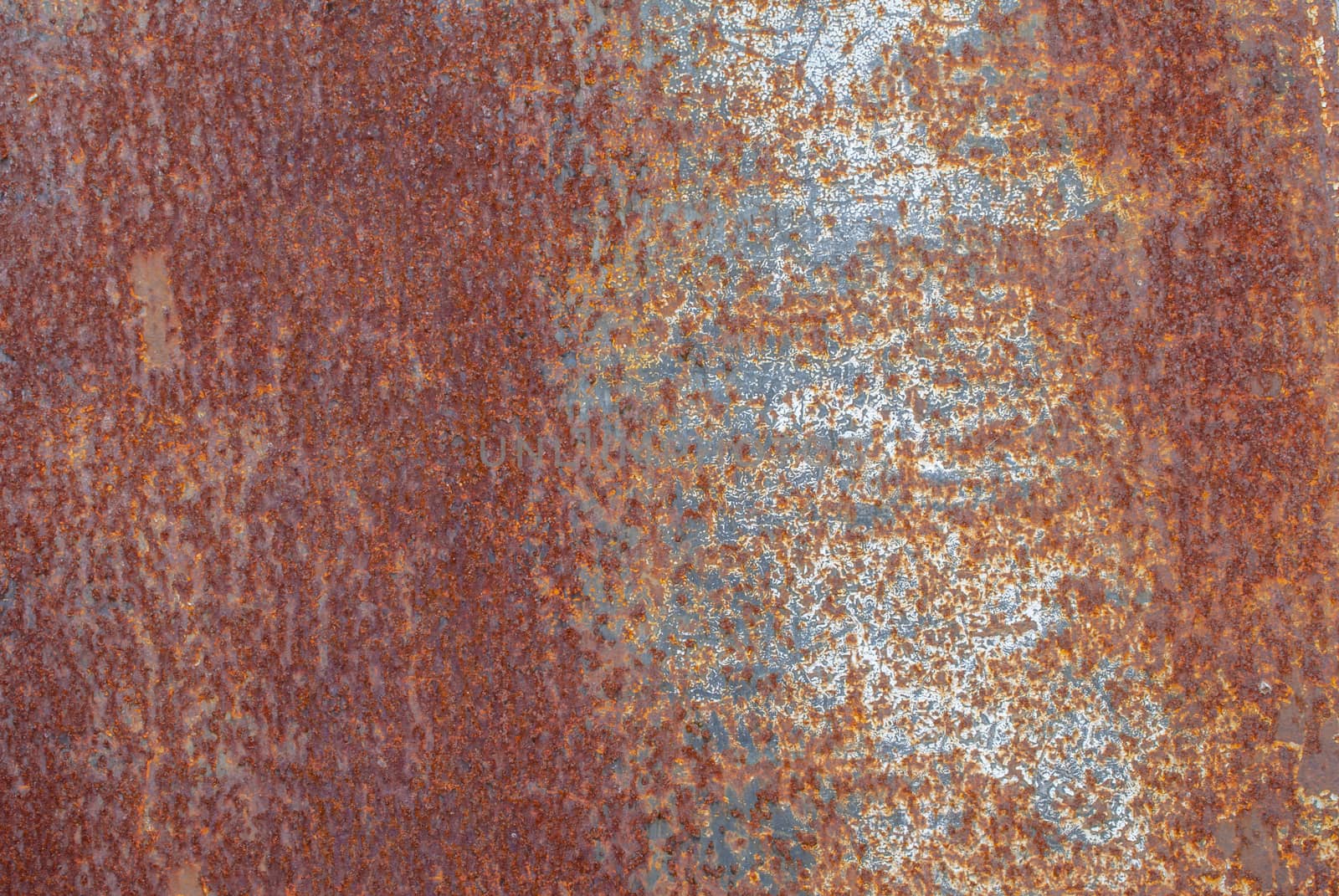 rusty iron surface covered with old chipped paint, which has long been influenced by different climatic conditions