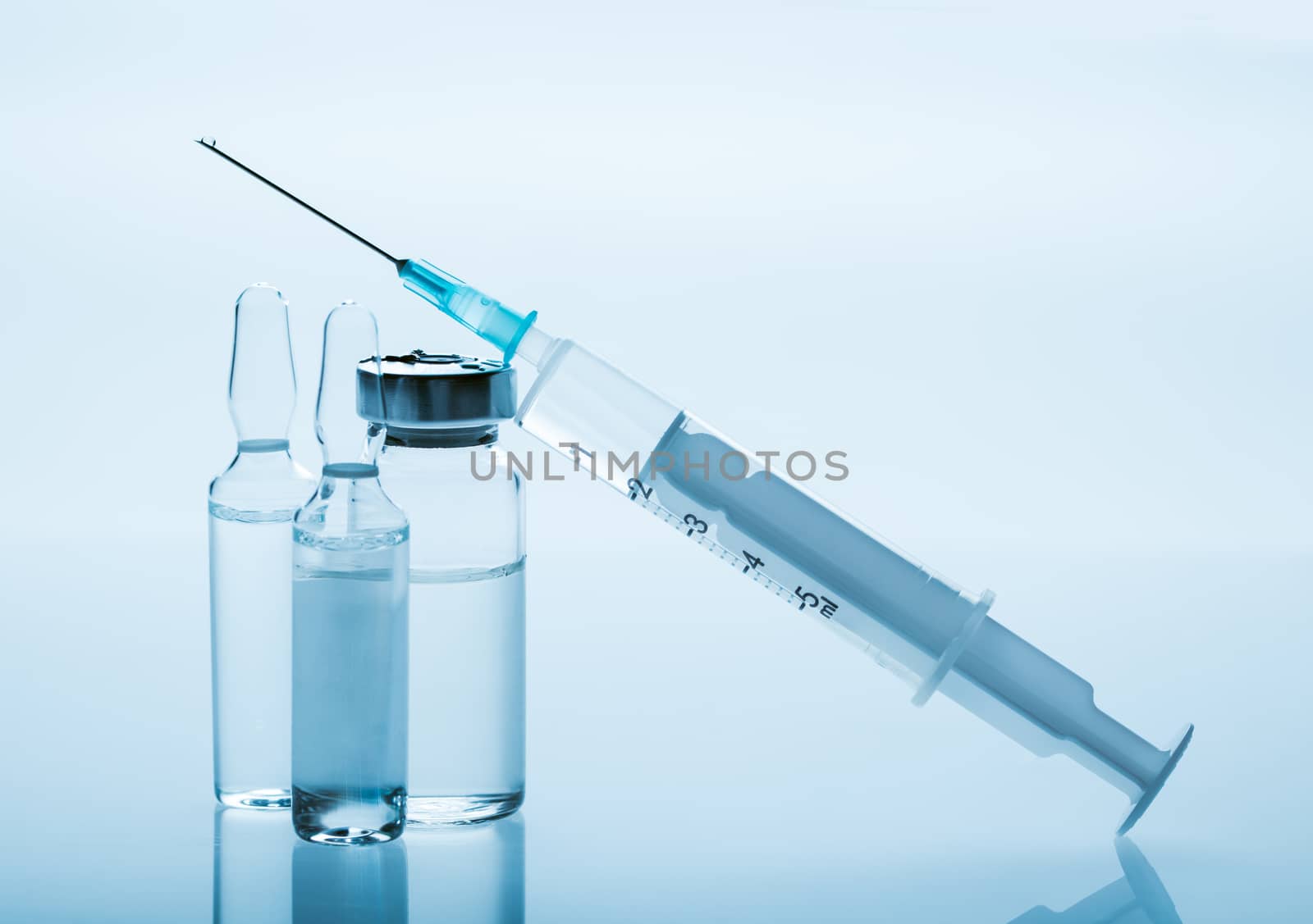 medicament in a glass vial and syringe closeup