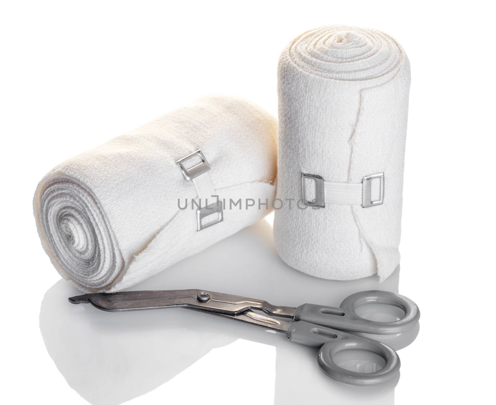elastic bandage and scissors closeup white background