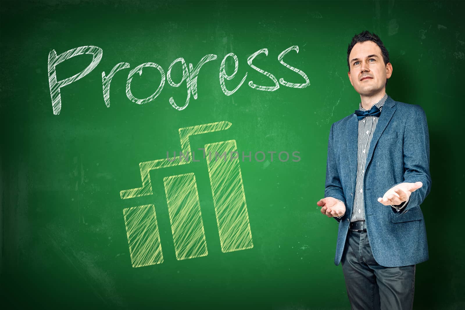 Businessman presenting progress with a graph on a chalkboard