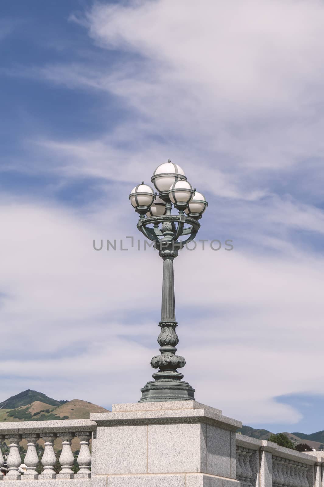 Ancient street lamp with white spheres in daylight
