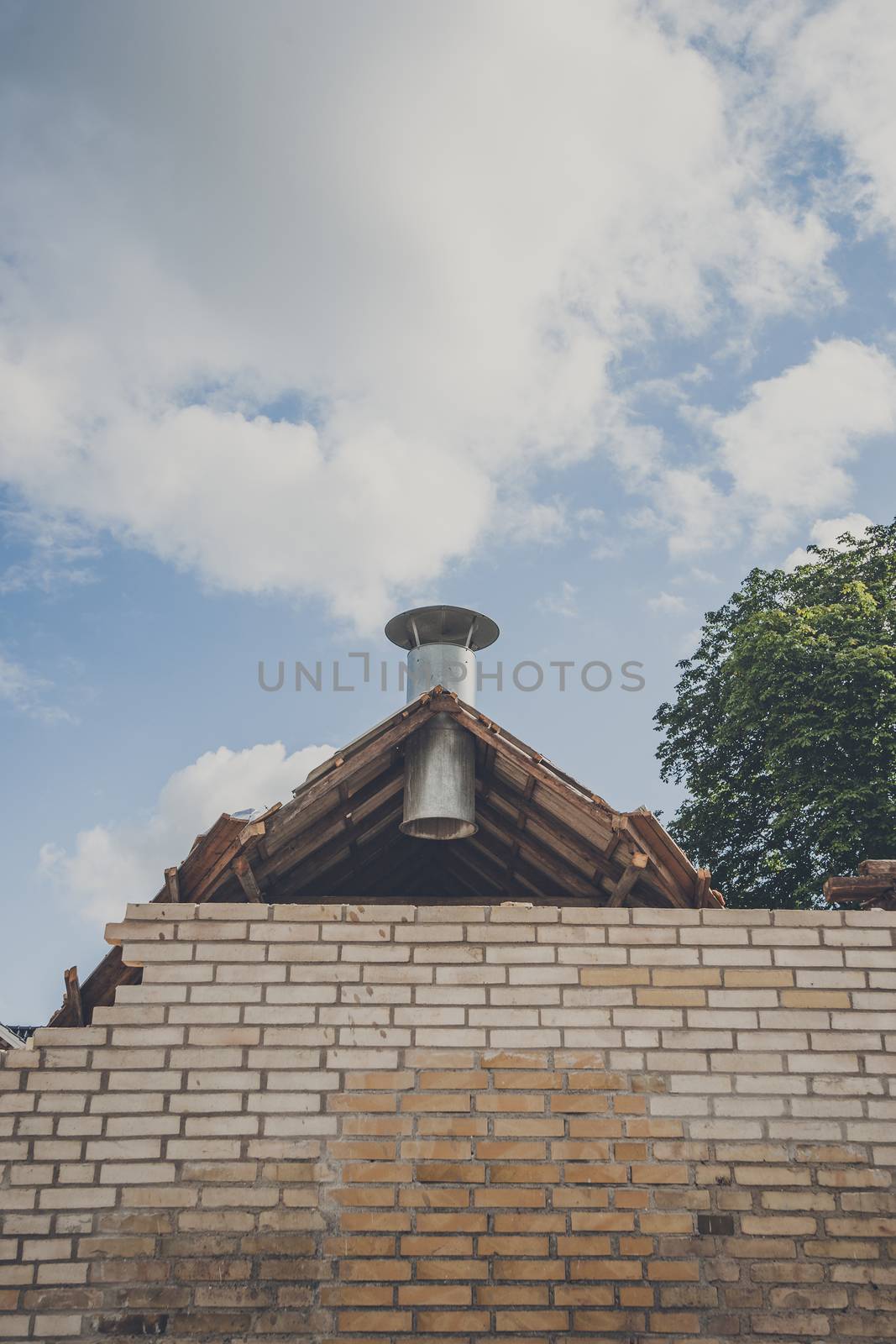 Steel chimney at a damaged building by Sportactive