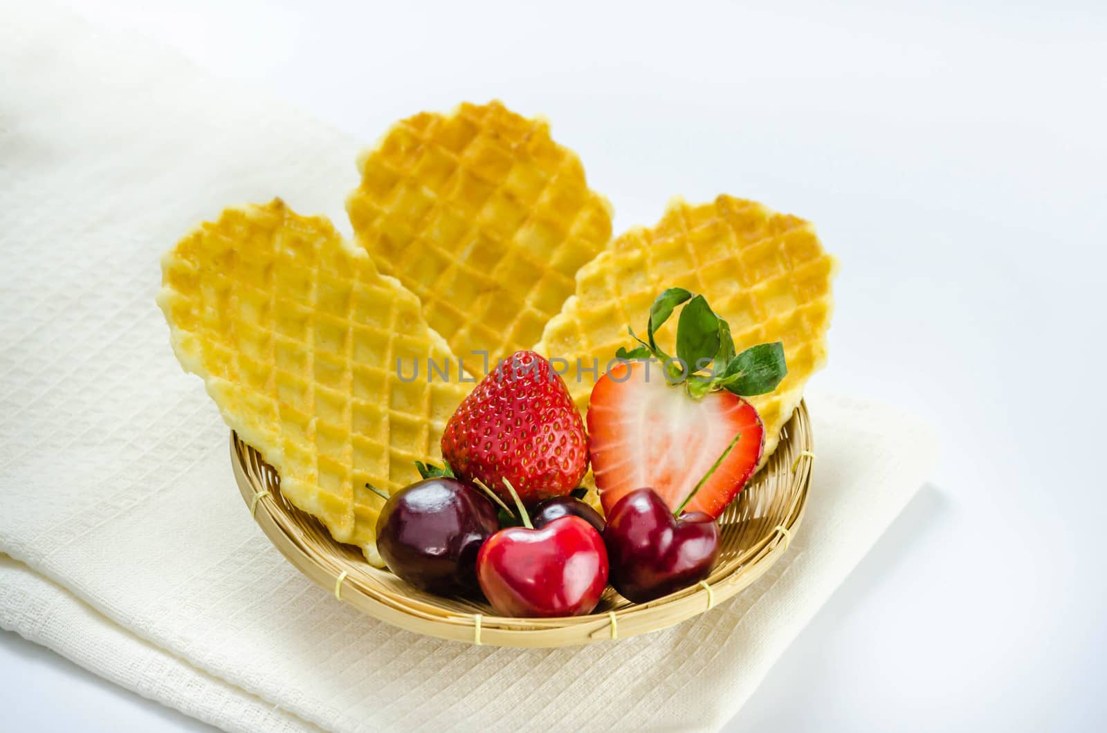 fresh berries fruit and waffles in bamboo basket