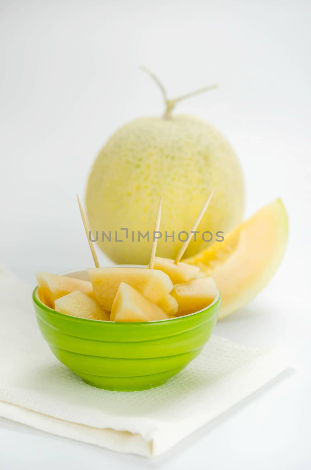 Ripe melon with slice on white background