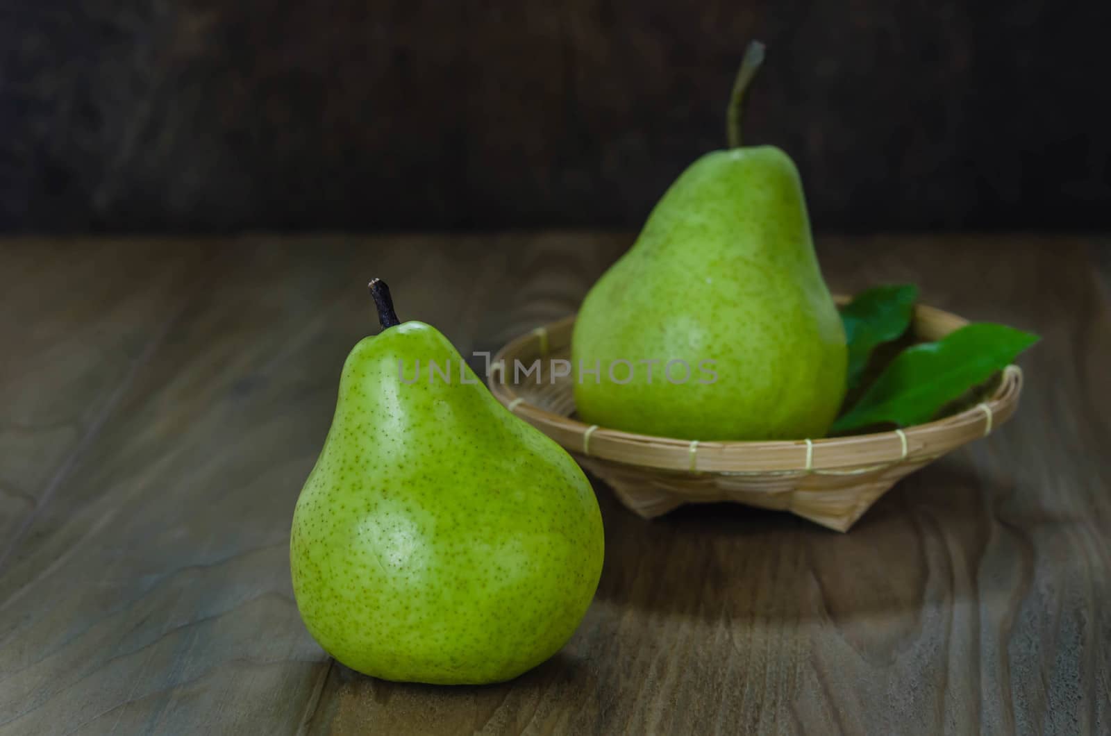 Fresh pears on the wooden background. Still life