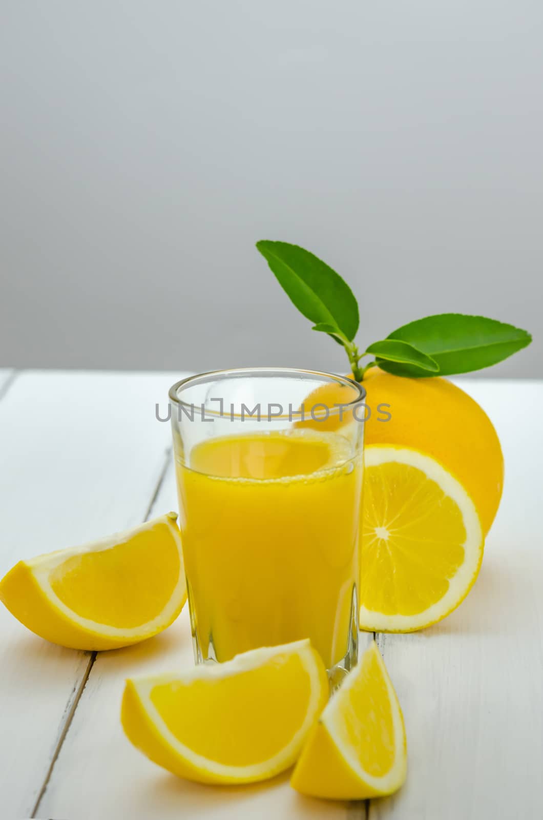 Orange juice and slices on wood